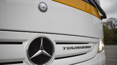Emblem of Mercedes - Benz on a Monbus coach.