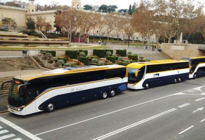 Monbus buses in front of the National Palace in Barcelona.