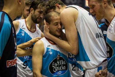 Albert Sàbat is hugged by his colleagues at the end of the match