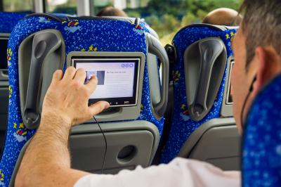 Traveller of Monbus using the multimedia screen of his/her seat