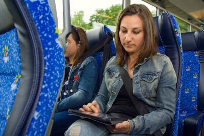 Passenger of Monbus using her tablet during a trip