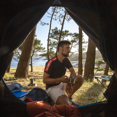 Image of a boy having a coffe in a tent