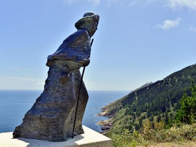 Pilgrim statue at the end of The Way in Fisterra