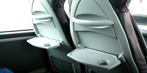 Collapsible tables on the back of the front seats